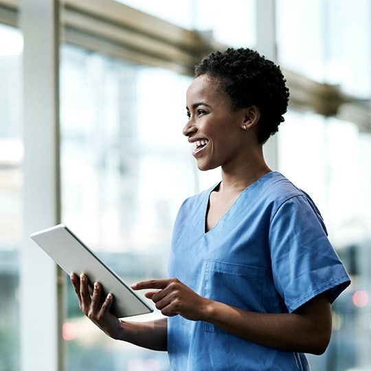 woman looking into a tablet