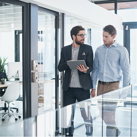 men looking into a tablet