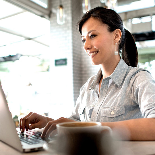 woman texting in her laptop