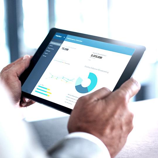 Automation solves several challenges in modern business close up of man holding a tablet with a graph on the screen