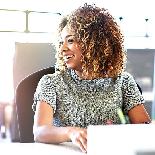 Automation can take any company to the next level woman smiling and working