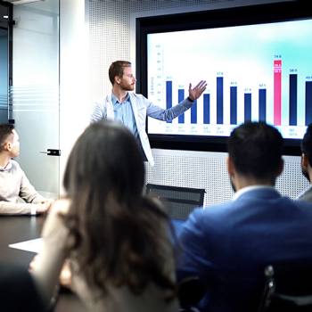 How digital platforms are rethinking business mode man presenting graph to a meeting
