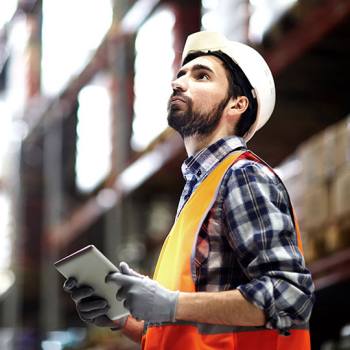 How to transform logistics management man wearing hard hat looking at tablet