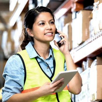 Handling procurement processes with ease warehouse worker on the phone holding a tablet