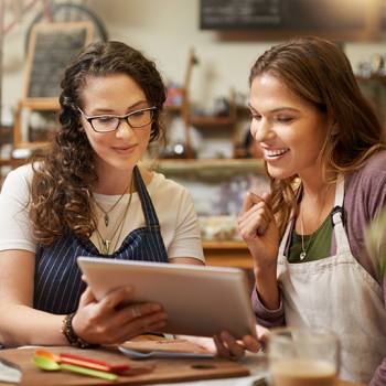 How to optimise sales cycles workers in overalls looking at tablet