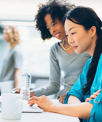 Improve medical staff credentialing and security two female colleagues working together at a laptop