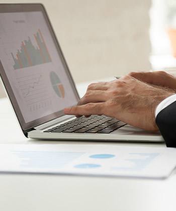 Gain close up of hands typing on a laptop keyboard