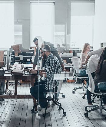 employees working in a glass office