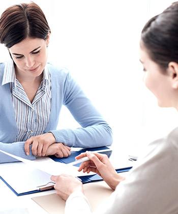 Make compliance easy  two women in a meeting